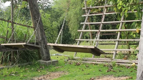 Empty swings swaying at backyard Stock Footage 88760362