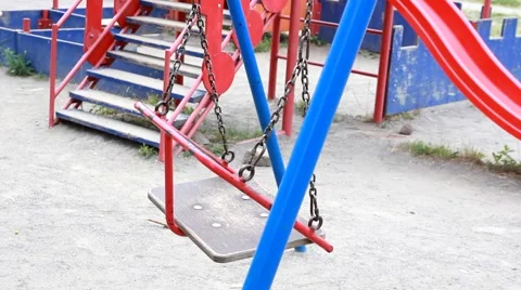 Empty swings swaying at playground Stock Footage 52194841