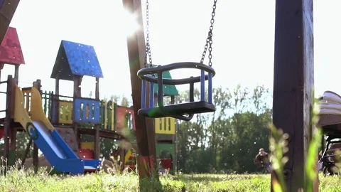 Empty swings swaying at playground Stock Footage 78486292