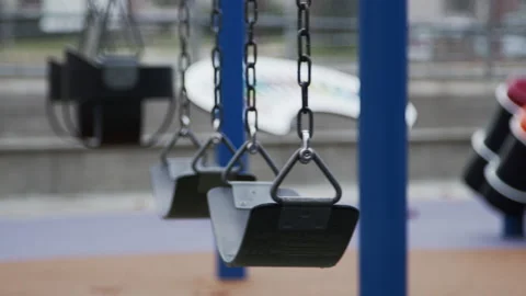 Empty Swingset in Motion Playground After Rain Covid 19 Coronavirus Lockdown Stock Footage 147569814