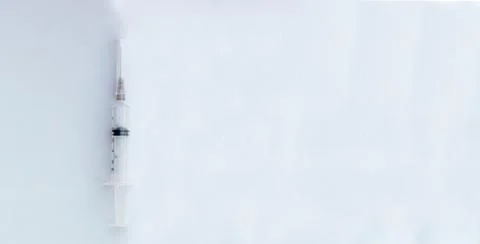 Empty Syringe against white void with copyspace. Stock Photos