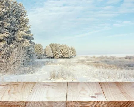 Empty table against the background of a winter landscape. Stock Photos