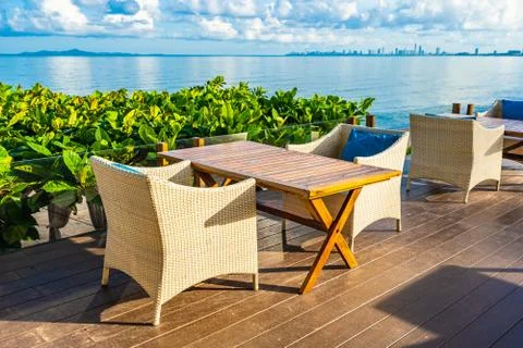 Empty table and chair for dining set nearly sea ocean beach on white cloud bl Stock Photos