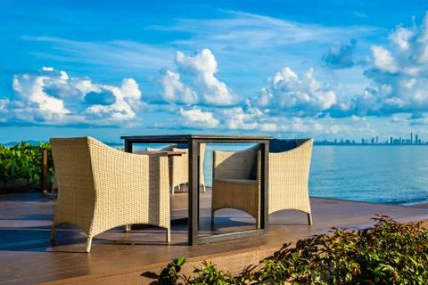 Empty table and chair for dining set nearly sea ocean beach on white cloud bl Stock Photos