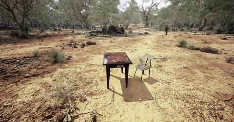 Empty table and chair set in arid Australian landscape under bright sun Illustrazione stock