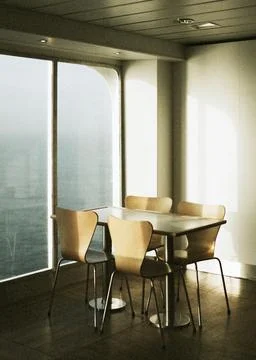 Empty table and chairs by a window on a ferry at sea Stock Photos