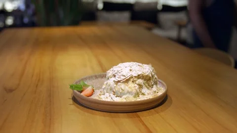 An empty table and on it stands a lonely plate with a piece of delicious Stock Footage 256143341