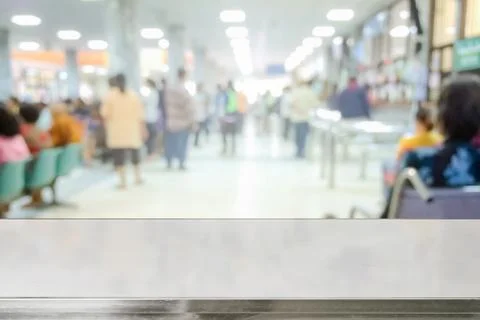 Empty table on Blur image of patients in the hospital waiting to doctor and Stock Photos