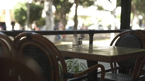 Empty table in a cafe overlooking the street Stock Footage 100992319