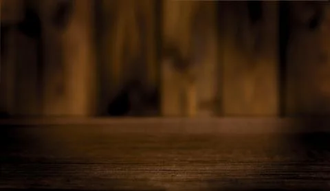 Empty table with a defocused wooden wall in the background. Stock Photos