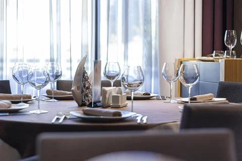 An empty table with dishes in a cafe or restaurant against the backdrop of a Stock Photos