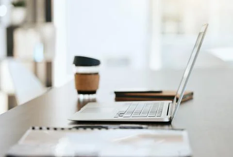 Empty table with files, coffee and laptop with notebook, folder and financial Foto stock