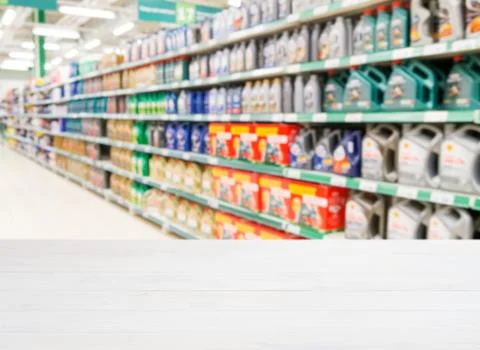 Empty table in front of blurred colorful motor oil bottles 스톡 사진