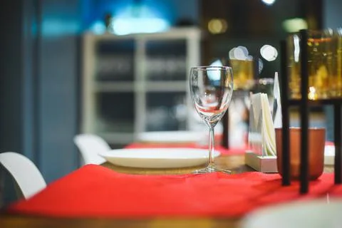 Empty table with red tablecloth served for reception of guests for dinner Stock Photos