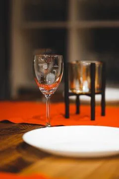 Empty table with red tablecloth served for reception of guests for dinner Stock Photos