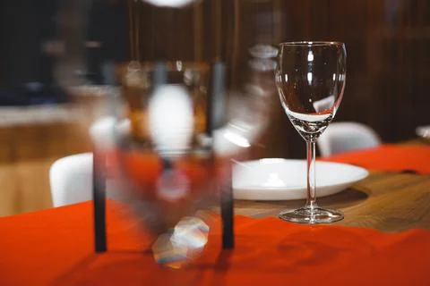 Empty table with red tablecloth served for reception of guests for dinner Stock Photos