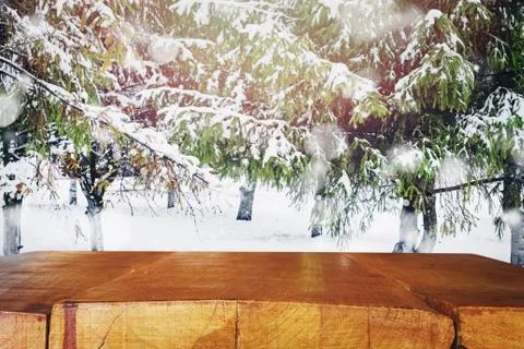Empty table top with blurred spruce trees with snow on the background. Stock Photos