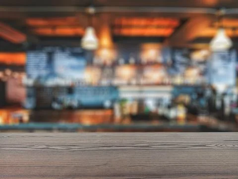 The empty table wooden board in front of the background is blurred. Stock Photos