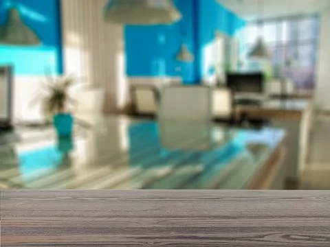 The empty table wooden board in front of the background is blurred. Stock Photos