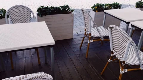 Empty tables and chairs in cafe outdoors, pandemic and hospitality industry Stock Footage 140403099