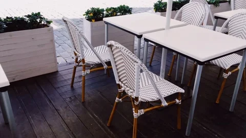 Empty tables and chairs in cafe outdoors, pandemic and hospitality industry Stock Footage 140426283