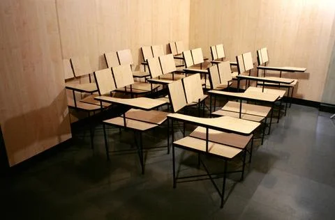 Empty tables and chairs in class Copyright: xVirenxDesai/DinodiaxPhotox  Stock Photos