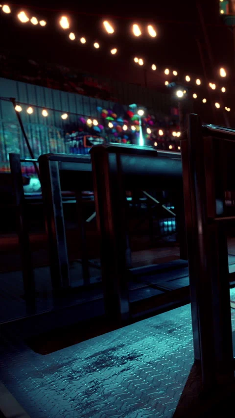 Empty tables and chairs in a night setting at a festive venue in the city Stock Footage 341058008
