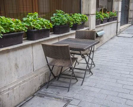 Empty tables and chairs outside of the restaurant in old city Stock Photos