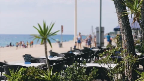 Empty Tables of Beachside Restaurant Next To Walkway Stock-Footage 103604145