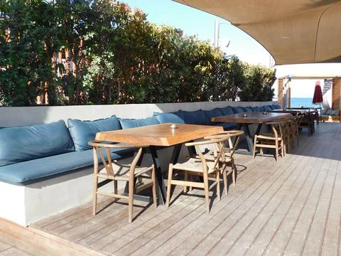 Empty tables in a cafe on the beach. Larnaca. Cyprus Stock Photos