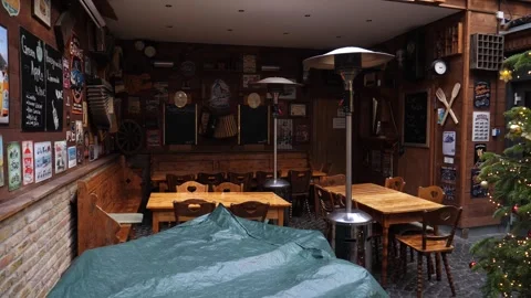 Empty tables of closed restaurant on a touristic street during holidays Stock Footage 296818258