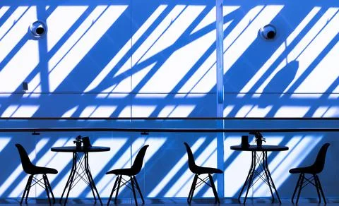 Empty tables in a mini cafe of a shopping center on the background of a geome Stock Photos
