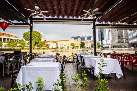 Empty tables at a riverside restaurant Stock Photos