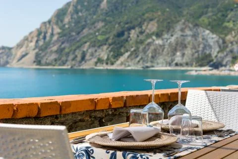 Empty tables waiting for guests in sea resort. Stock Photos