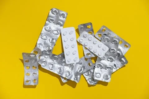 Empty tablet blister pack against a monochrome background top view Stock Photos