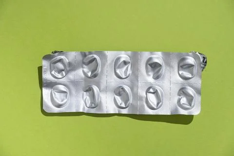 Empty tablet blister pack against a monochrome background top view Stock Photos