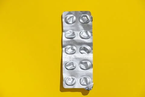 Empty tablet blister pack against a monochrome background top view Stock Photos
