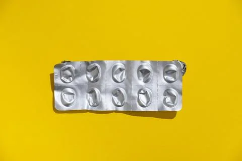 Empty tablet blister pack against a monochrome background top view Stock Photos