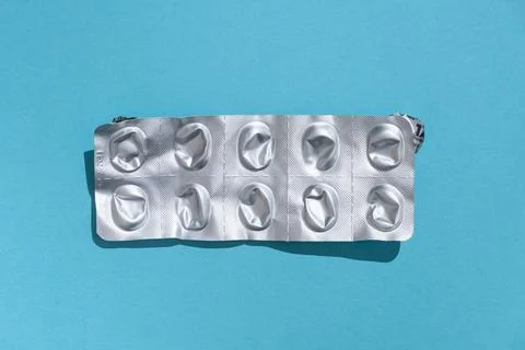 Empty tablet blister pack against a monochrome background top view Stock Photos