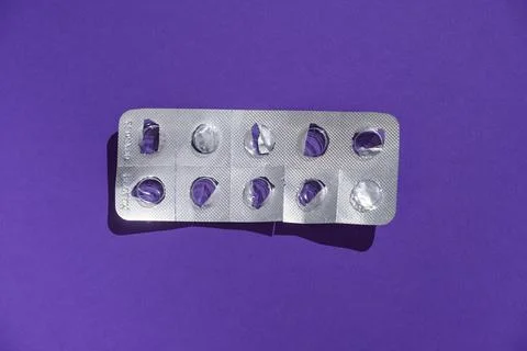 Empty tablet blister pack against a monochrome background top view Stock Photos