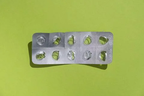 Empty tablet blister pack against a monochrome background top view Stock Photos