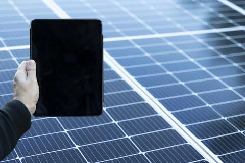 Empty tablet with copy space with some solar panels on the background Stock Photos