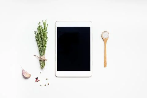 Empty tablet PC with greens herbs and spices Stock Photos