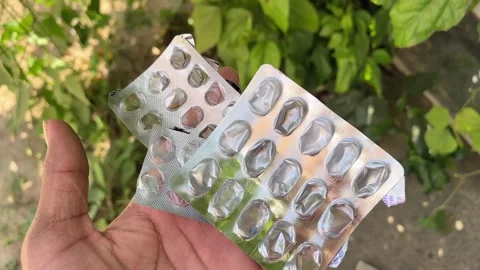 Empty Tablet Strip in Hand | Medicine Blister Pack Close-Up Macro Video 動画素材 318840369