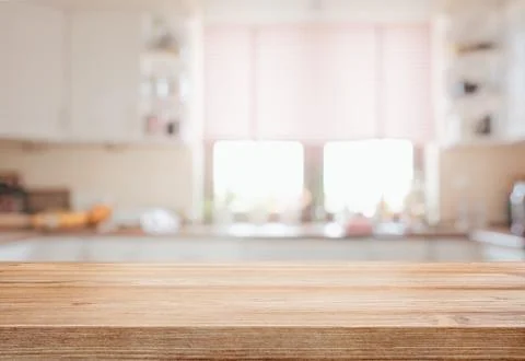 Empty tabletop over defocused kitchen with copy space Stock Photos