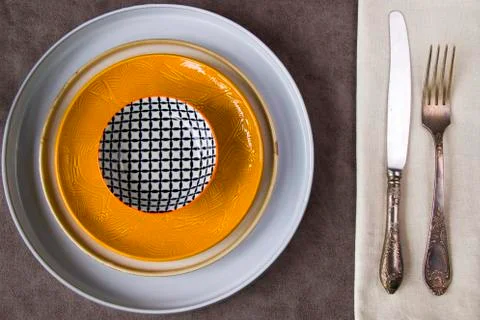 Empty tableware and dishware settings and serving on the gray background Stock Photos