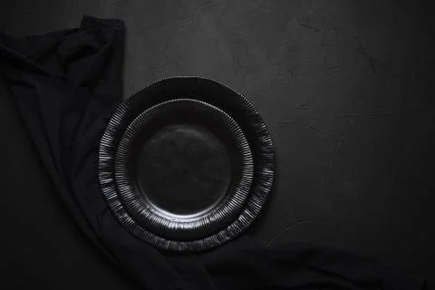 Empty tableware and towel. Black plates on table. Empty dishes Stock Photos