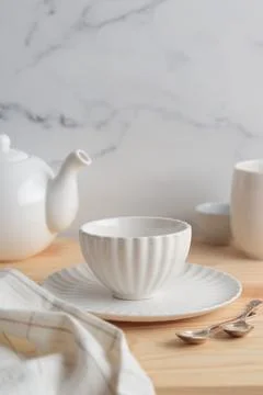 Empty tableware - white plate, a bowl and a cup on wooden table as a backgr.. Stock Photos