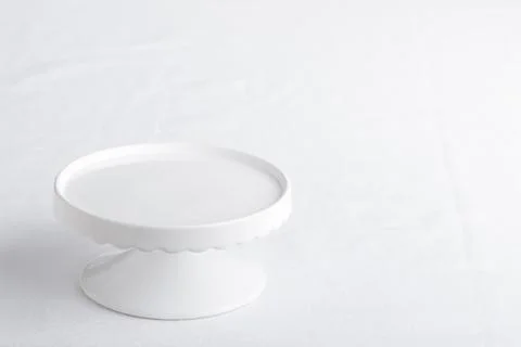 Empty tableware - white plate cakestand on white table as a background for a  Stock Photos