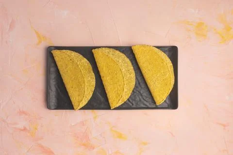 Empty taco shells on board on dark background Foto stock